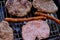 Traditional serbian barbecue rostilj  homemade sausages and burgers. Preparing a barbecue on a grill, outdoor roasting meat. Tra