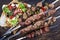 Traditional Shashlik with Salad and Yufka Bread on an rustic burnt cutting board