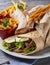 Traditional Shawarma Delight: Savory Chicken, Fries, and Fresh Veggies Wrapped in Pita - Rustic Brown Wall Setting. AI Generated