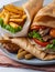 Traditional Shawarma Delight: Savory Chicken, Fries, and Fresh Veggies Wrapped in Pita - Rustic Brown Wall Setting. AI Generated