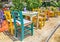 Traditional sidewalk greek tavern with multicolored tables and