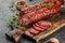 Traditional slice salami sausage with spices on a wooden board. banner, menu, recipe place for text, top view