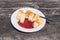 Traditional Slovene Struklji with strawberry jam an white plate,