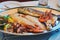 Traditional slovenian cuisine, mixed grilled fish and seafood with garlic oil. Selective focus