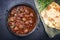 Traditional slow cooked American Tex-Mex meatballs chili with mincemeat and beans in a spicy sauce with pita bread