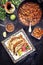 Traditional slow cooked Mexican chili con carne with tortillas on a colored plate