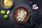 Traditional slow cooked Mexican pozole rojo with tortilla in a cast-iron roasting dish