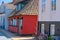 a traditional small,red,danish framehouse in summer in Bornholm with blue sky