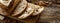 Traditional sourdough loaf of bread sliced smeared with butter baked in a craft bakery on a wooden table