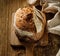 Traditional sourdough loaf of bread on a wooden board