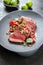 Traditional South American barbecue wagyu roast beef sliced with pico de gallo and salsa verde garnished