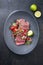 Traditional South American barbecue wagyu roast beef sliced with pico de gallo and salsa verde garnished in a modern design plate