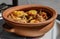 Traditional South American carbonada criolla (beef stew) in a rustic clay pot. Salta, Argentina