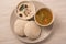 Traditional south indian food, idli or idly with sambar and white coconut coconut in white plate.