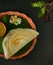 Traditional south indian food masala dosa, sambar and coconut chutney served on clay plate and banana leaf. studio shot