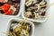 The traditional Spanish appetizers of olives, tomatoes and anchovies in a white ceramic bowls