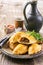 Traditional Spanish baked empanada de carne with minced meat and vegetable on a rustic plate