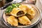 Traditional Spanish baked empanada de carne with minced meat and vegetable on a rustic plate