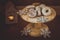 Traditional Spanish Christmas cookies polvorones, nevaditos and mantecados on a wood cake stand, lit candle