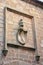 Traditional, Spanish coat of arms is depicted on an old heraldic shield carving on a wall