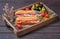 Traditional Spanish ham sandwiches with slices fuet and jamon on wooden tray