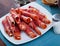 Traditional Spanish meal - rolls of iberian jamon served at plate