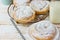 Traditional Spanish or Philippine pastry ensaimada. Powdered, on cooling rack and plate. Glass of milk