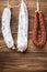 Traditional spanish smoked sausages meat hanging on wood table