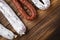 Traditional spanish smoked sausages meat hanging on wood table with space for text