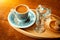 Traditional sparkling turkish coffee served with porcelain cup, cookies, glass of water and flower
