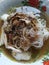 traditional spicy balinese chicken soup with vermicelli and fried onions