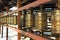 Traditional spinning prayer wheels at temple complex, asian culture of Hindu and Buddhist faith at local monastery