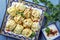 Traditional steamed Russian pelmeni with yoghurt cayenne pepper on a rustic design plate