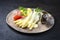 Traditional steamed white asparagus with cured ham and boiled potatoes garnished with sauce hollandaise