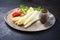 Traditional steamed white asparagus with cured ham and boiled potatoes garnished with sauce hollandaise on a rustic design plate