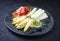 Traditional steamed white asparagus with cured ham and garnished with sauce hollandaise on a Nordic design plate