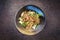 Traditional stir-fried Thai phat phak kung with mie noodles in a bowl