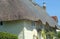 Traditional stone cottage with reed thatched roof