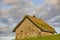 Traditional stone house with turf roof in Faroe islands. Sunset