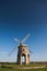 Traditional stone windmill under blue skies