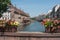 Traditional stoned bridge on IL river with flowers at little France quarter in Strasbourg