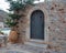 Traditional stonewall building at Mani Laconia, Peloponnese Greece. Ceramic pot with green plant