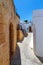 Traditional street with white houses in Lindos village, Rhodes island, Dodecanese, Greece.