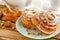 Traditional Swedish bakery or kanelbulle with walnuts on wooden tray. Breakfast or snack concept.