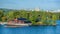 Traditional swedish falun red wooden houses and piers on Fjaderholmarna Feather Islands, nearest archipelago islands from