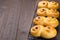 Traditional Swedish and scandinavian Christmas saffron buns Lussekatter on cooling tray, brown wooden backgtound, horizontal, copy