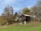 Traditional Swiss architecture and wooden alpine houses in the autumn environment of mountain pastures and mixed forests