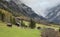Traditional Swiss architecture and wooden alpine houses in the autumn environment of mountain pastures and mixed forests