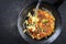 Traditional Swiss rosti as side dish with leek in a wrought iron frying pan