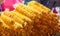 Traditional Thai Asian homemade tasty appetizer snack, crispy golden potato chip sticks on street food market stall. Food Travel,